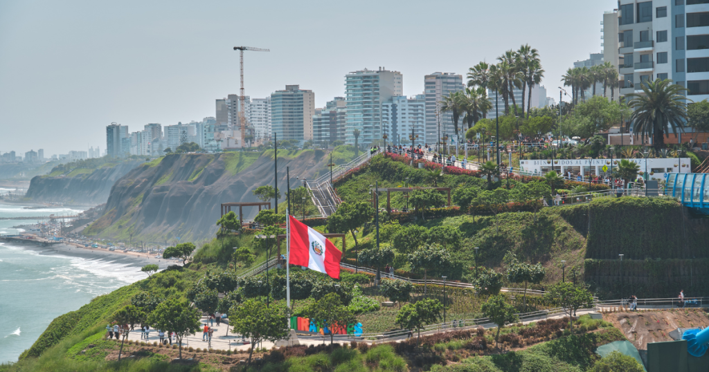 Picture of Lima's waterfront with a Peruvian Flag showcasing one of the best cities to learn Spanish in Latin America