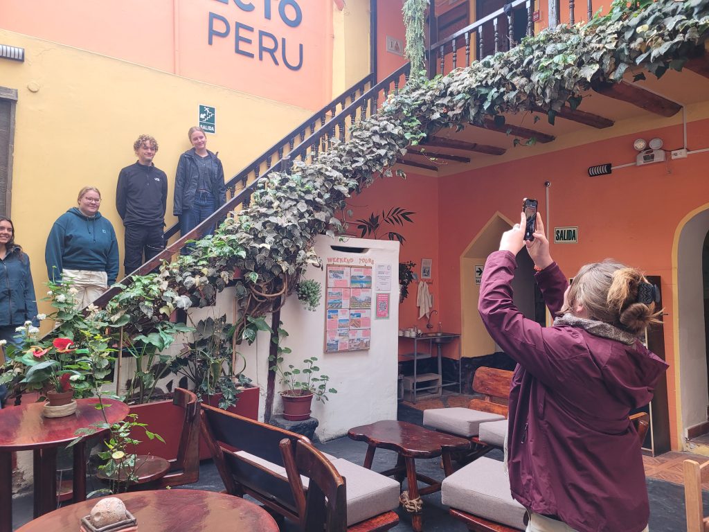 Marketing Intern Cali takes photo of new volunteer, interns and students in Cusco