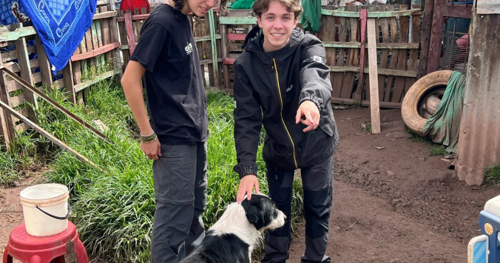 Volunteers with a dog at the dog shelter in Cusco