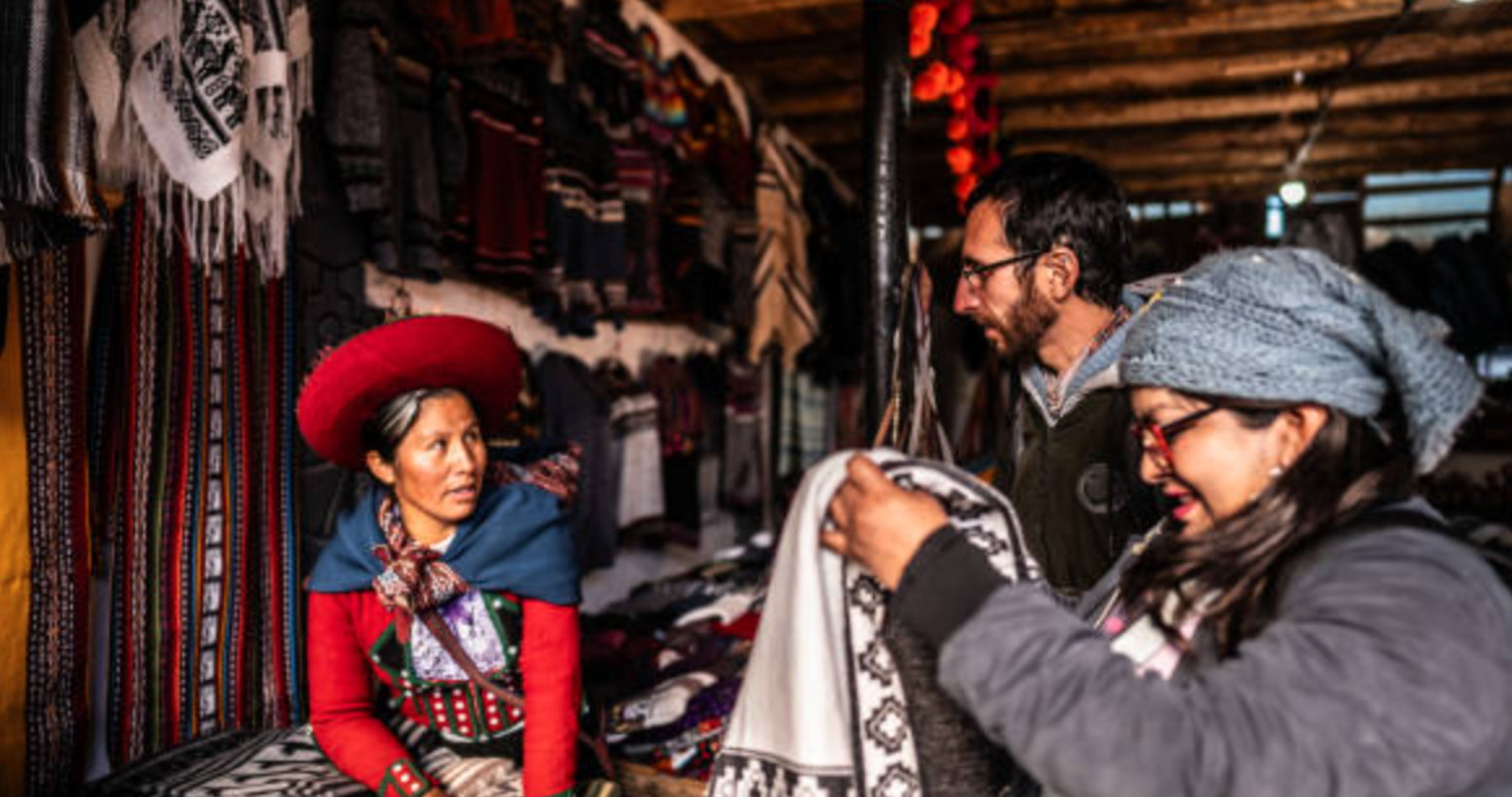 People talking to a local at a market