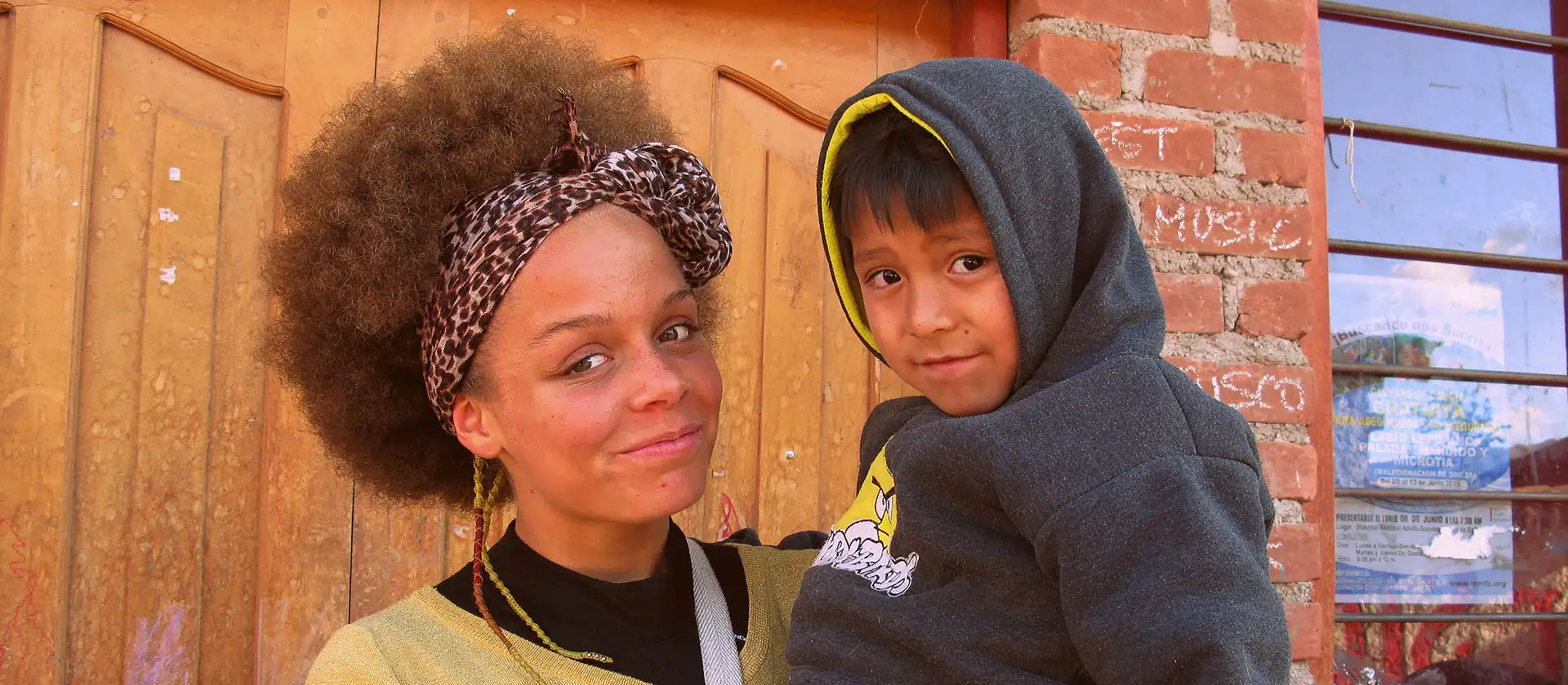 Volunteer holding Peruvian child