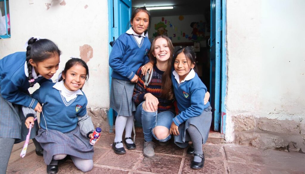 Volunteer with local students in Cusco Peru