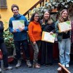 Spanish Students and volunteers stand with the certificates in Cusco